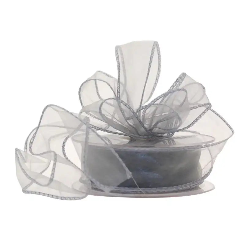Sheer silver organza ribbon with wired edges, perfect for gift wrapping and home décor accents.