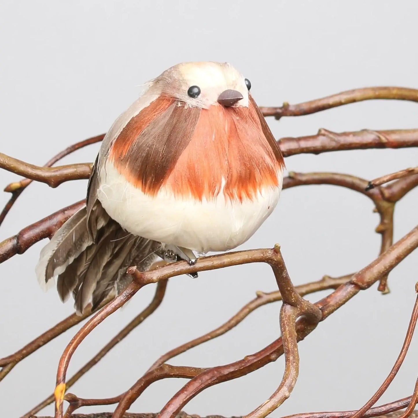 Adorable faux robin bird perched on rustic branches, perfect for home décor and seasonal gifts
