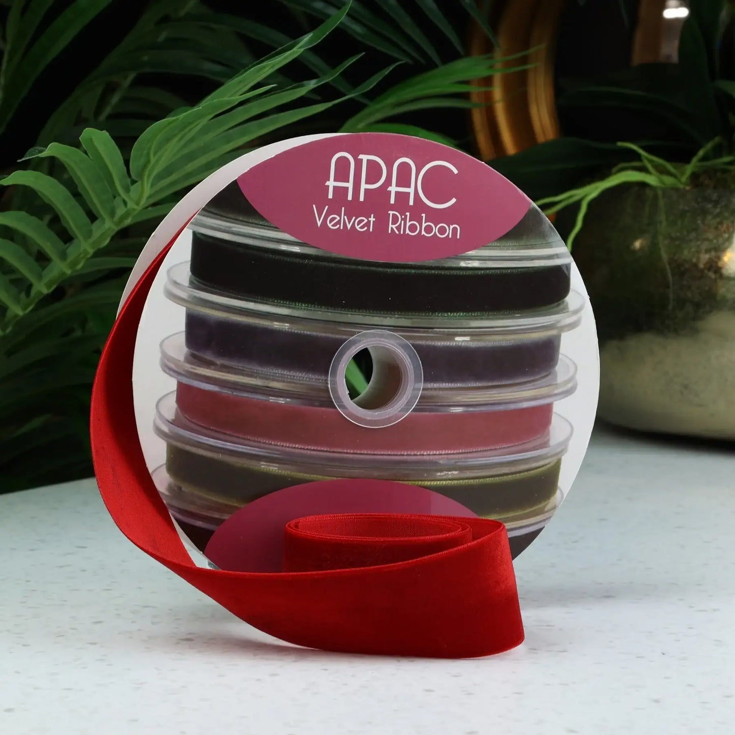 APAC Velvet Ribbon spool with red ribbon unrolled, perfect for gift wrapping and home décor accents