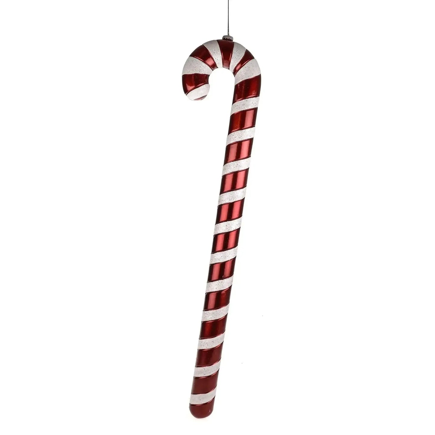 Red and white striped candy cane Christmas decoration hanging on a white background