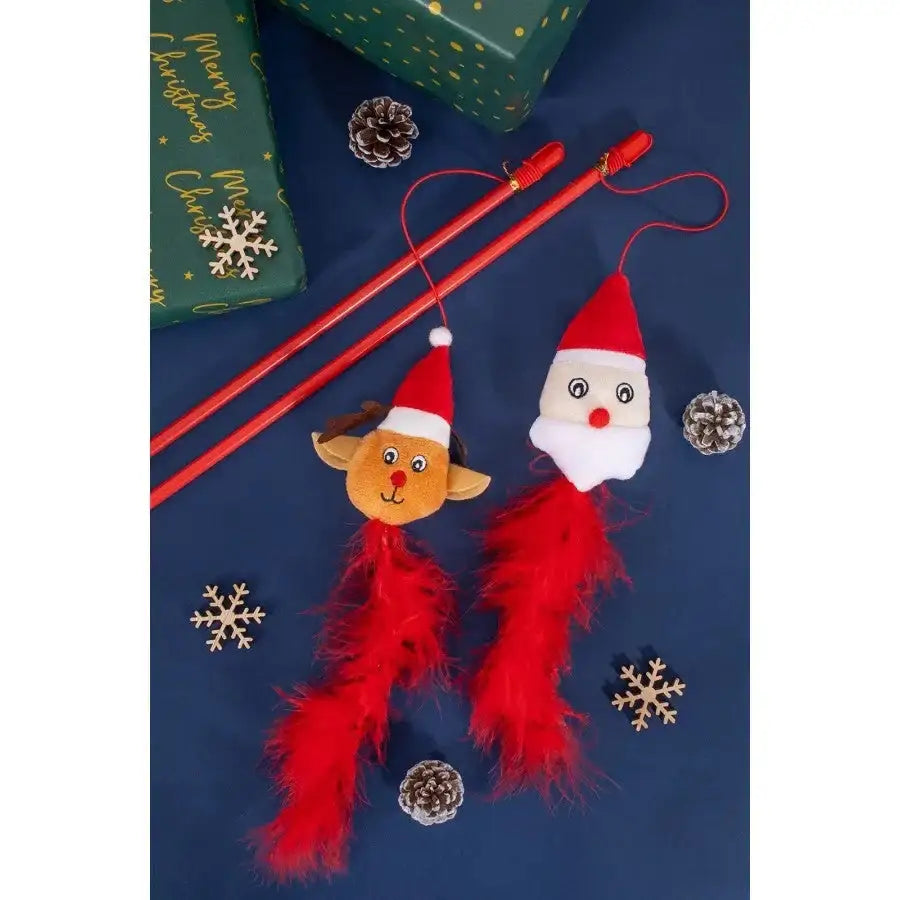 Festive cat teaser toys with Santa and reindeer plush, red feathers, pinecones, and Christmas gift wrapping.