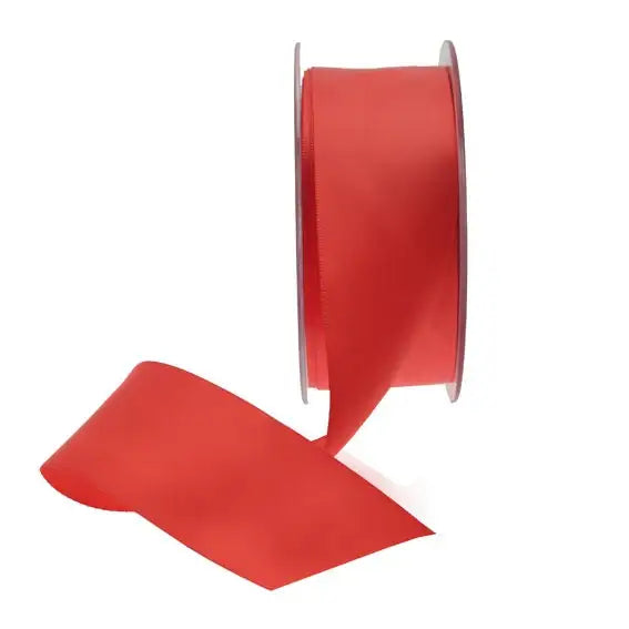 Vibrant red satin ribbon spool for gift wrapping and home décor accents