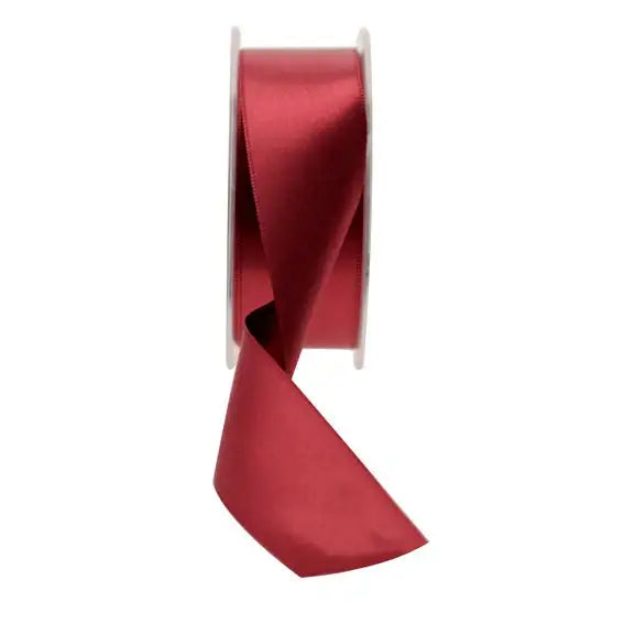 Rich red satin ribbon spool for gift wrapping and home décor accents