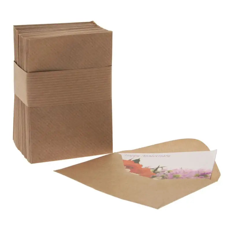 Happy Anniversary card with floral design in kraft envelope, stack of matching envelopes beside