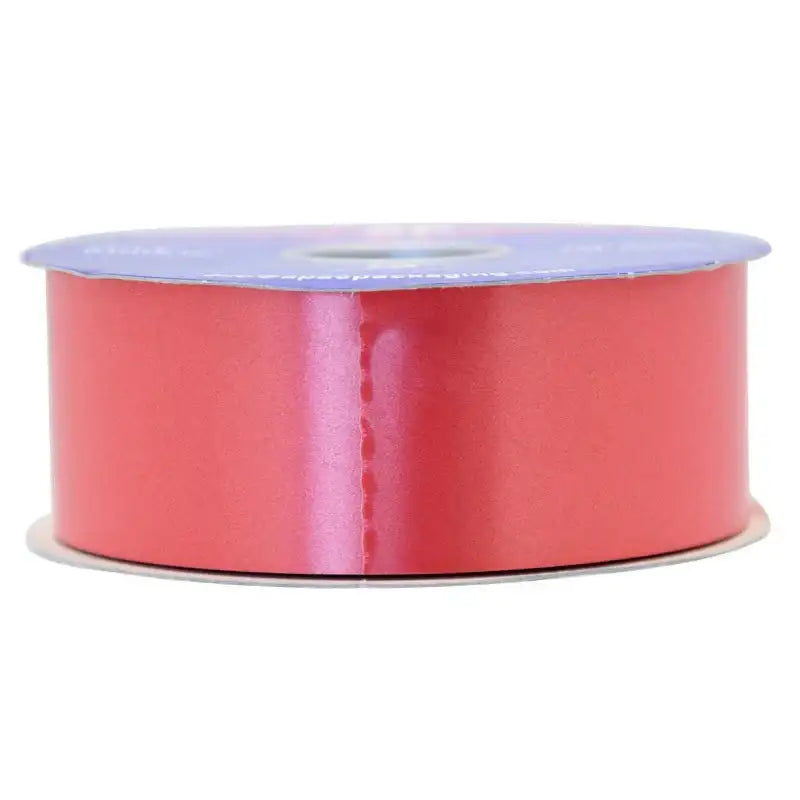 Coral satin ribbon spool for gift wrapping and home décor accents
