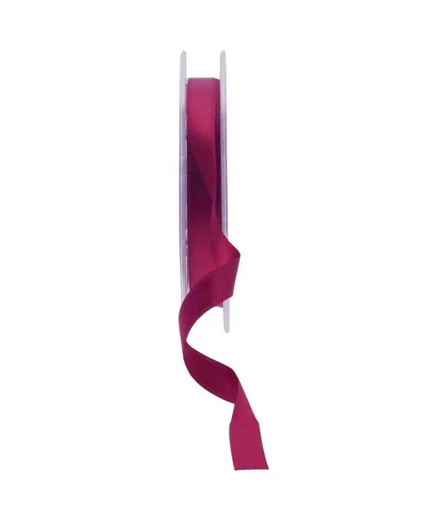 Burgundy satin ribbon on spool for gift wrapping and home décor accents