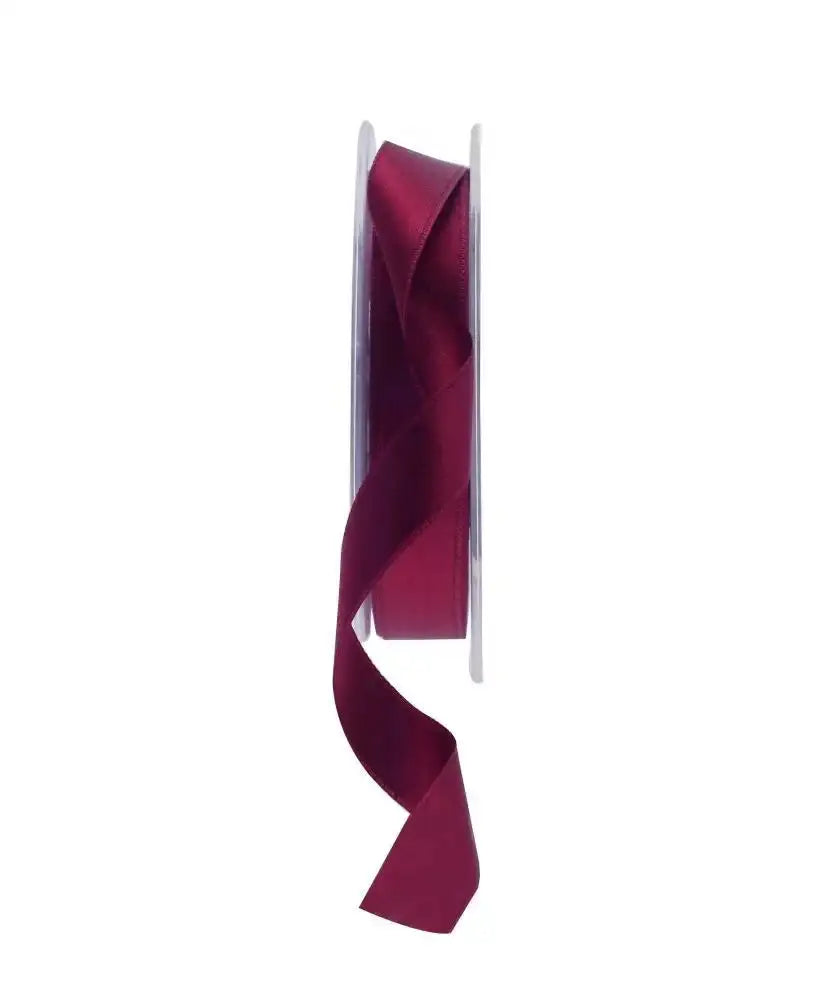Burgundy satin ribbon on spool for gift wrapping and home décor