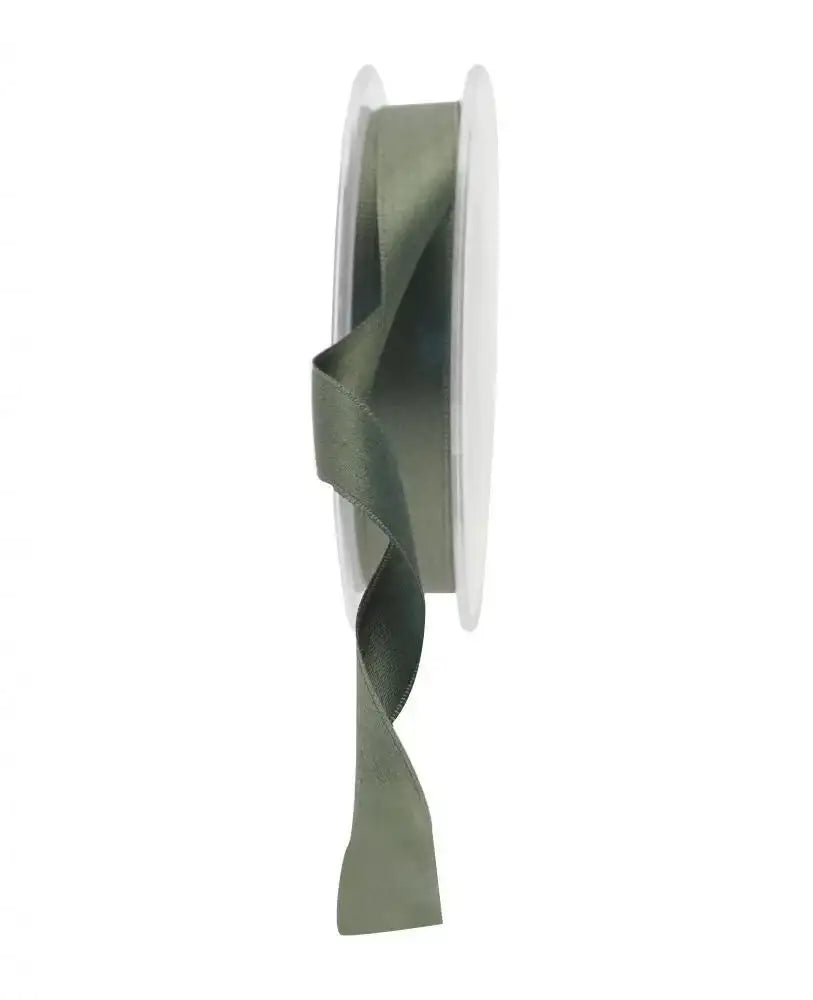 Sage green satin ribbon on spool for gift wrapping and home décor accents