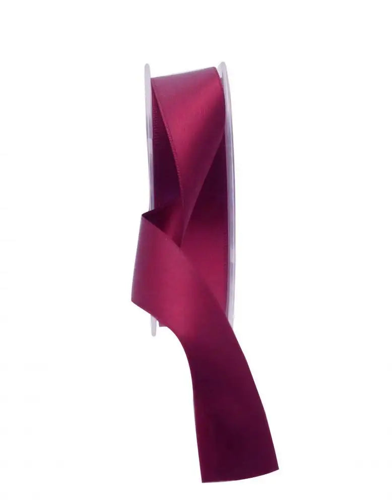 Burgundy satin ribbon spool for gift wrapping and home décor accents