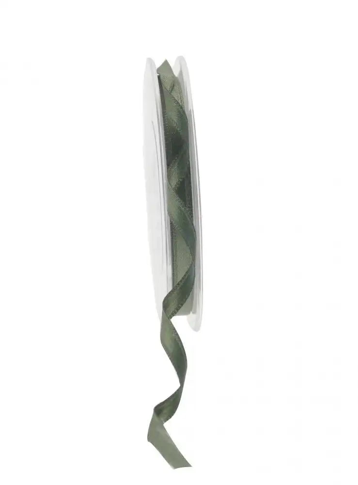 Sage green satin ribbon on spool for gift wrapping and home décor accents