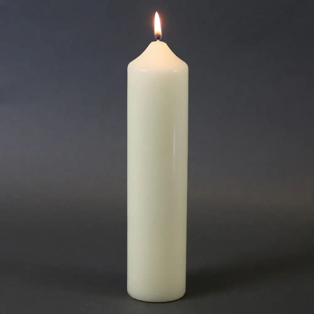 Lit white pillar candle for home décor and celebrations, creating warm ambiance