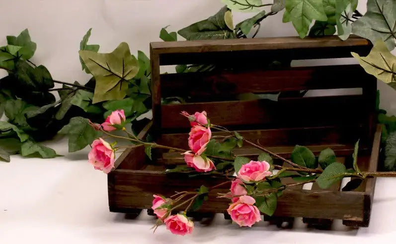 Pink artificial roses in rustic wooden crate with green ivy, perfect for home décor and gift occasions