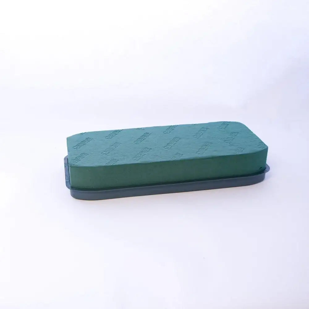 Green floral foam block in gray tray for DIY flower arrangements and home décor projects