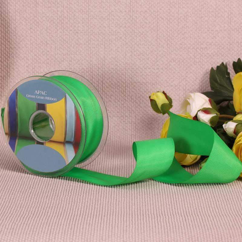 Bright green grosgrain ribbon spool with floral accents, perfect for gift wrapping and home décor