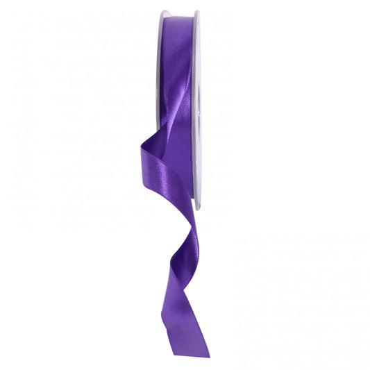 Purple satin ribbon on spool for gift wrapping and home décor accents