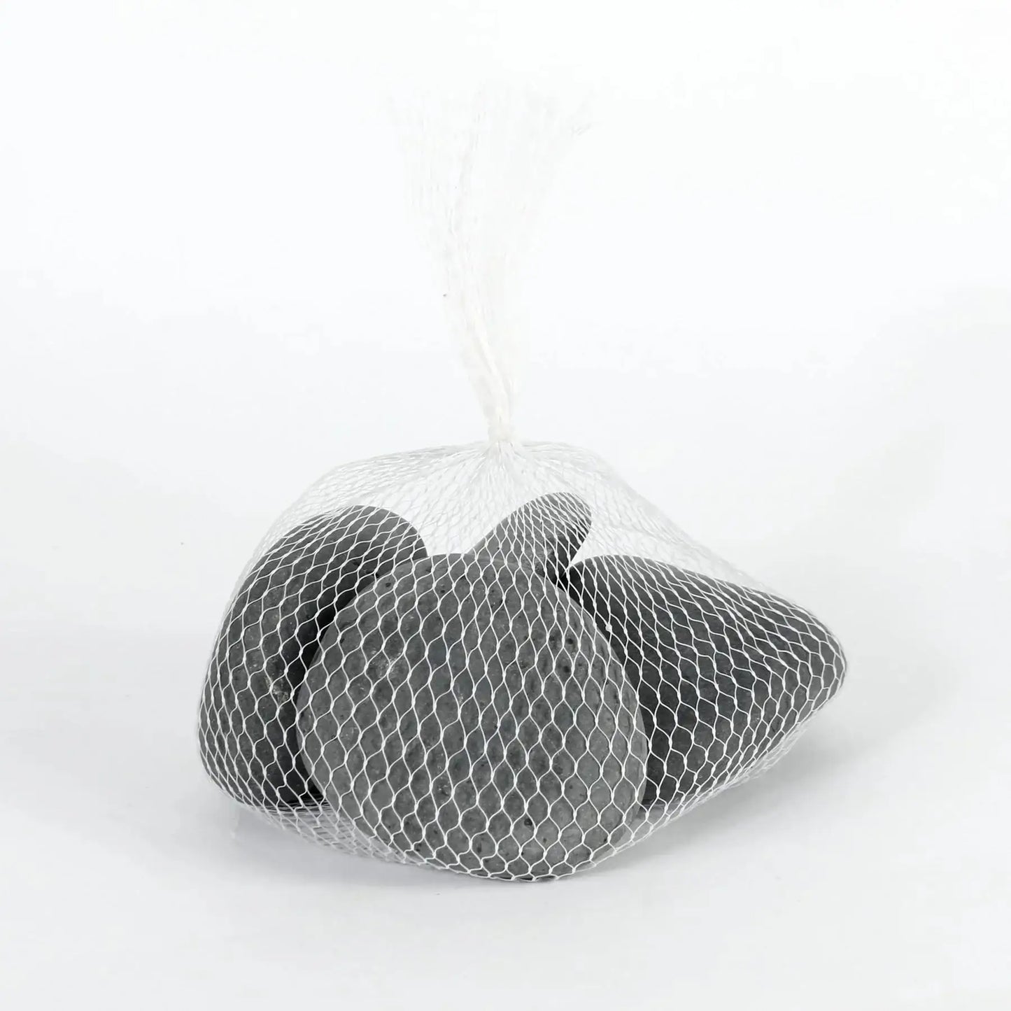 Smooth gray decorative pebbles in a white mesh bag on a plain background
