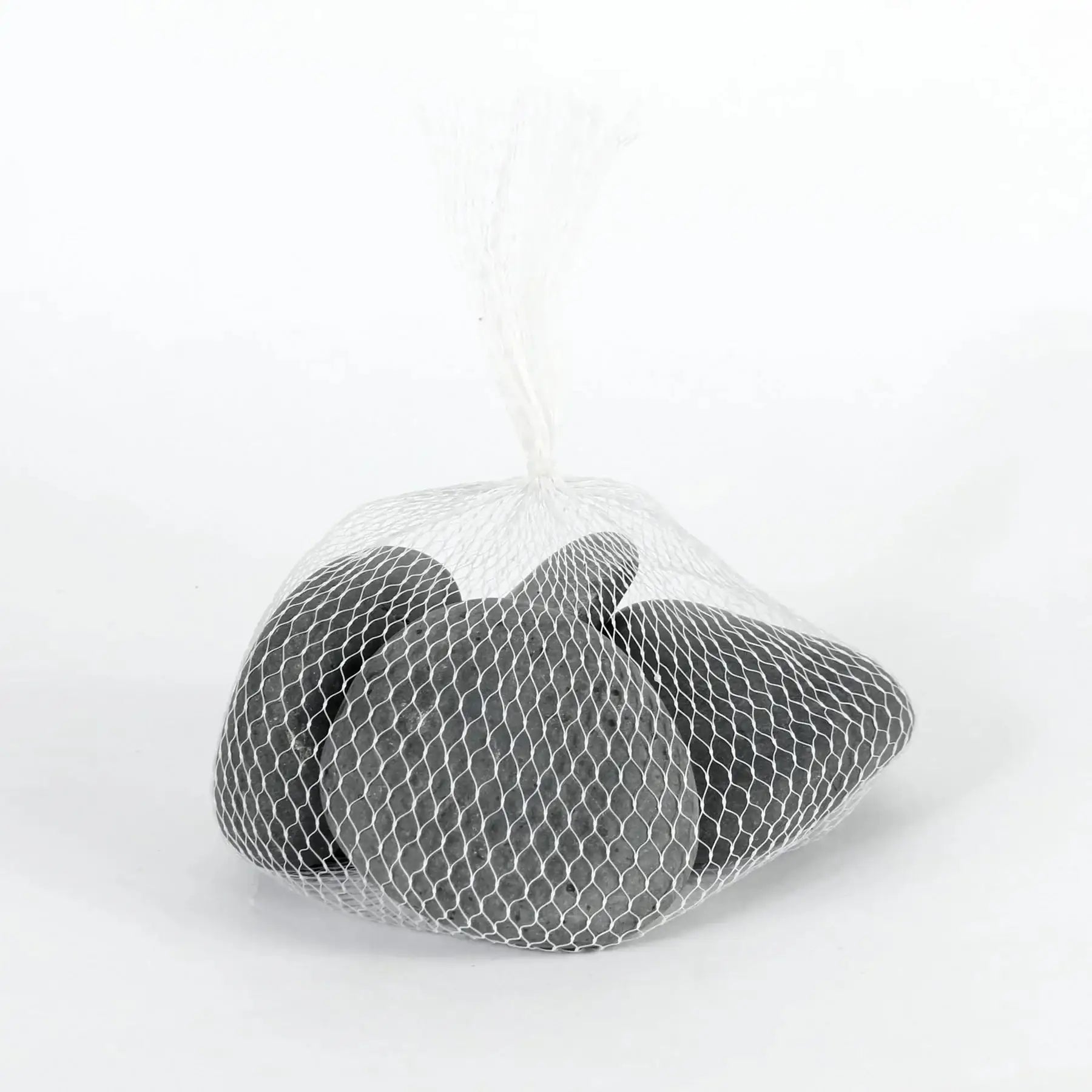 Smooth gray decorative pebbles in a white mesh bag on a plain background