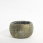 Round ceramic planter with rustic textured finish and geometric carved pattern, home decor accent