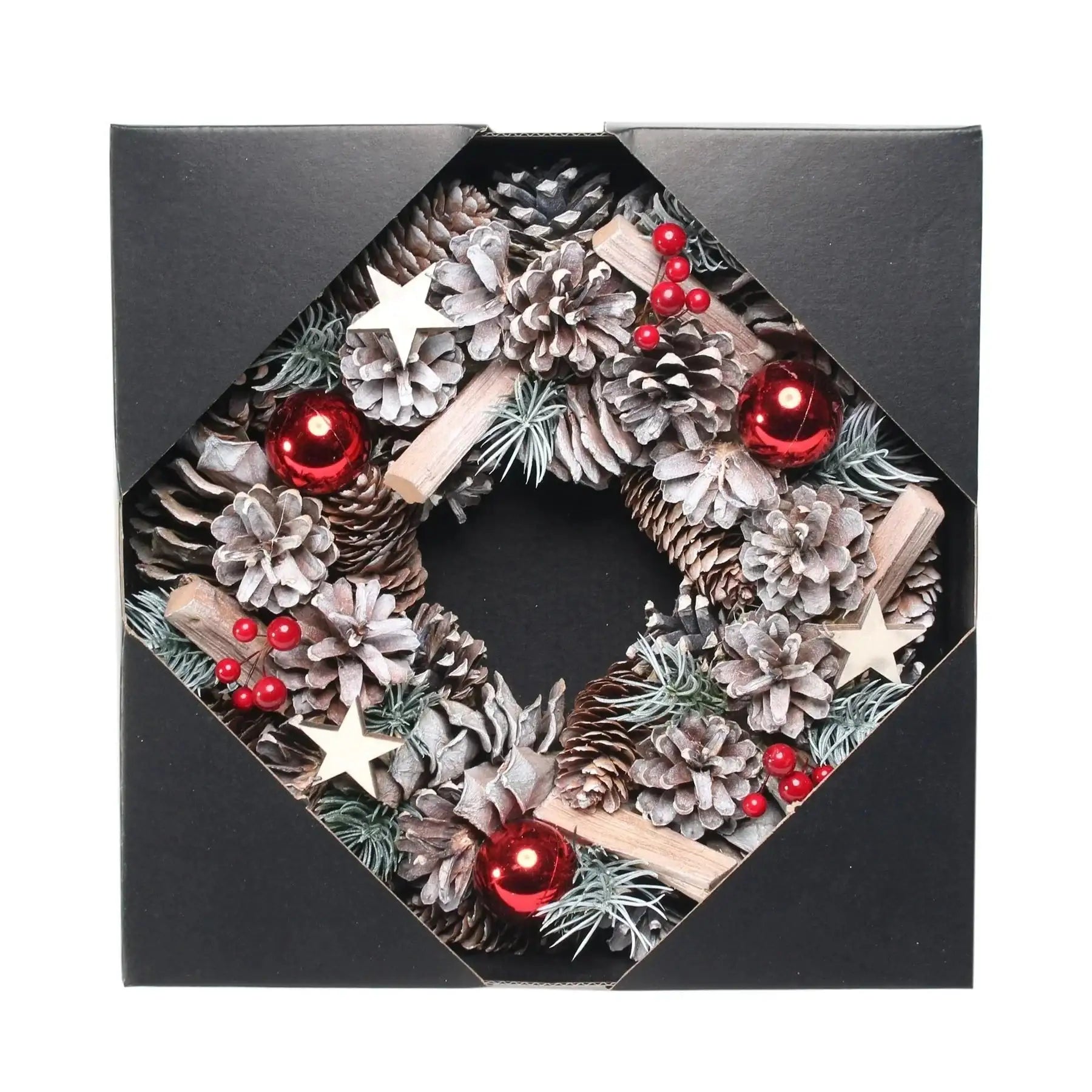 Festive pinecone wreath with red ornaments, berries, and wooden stars in gift box