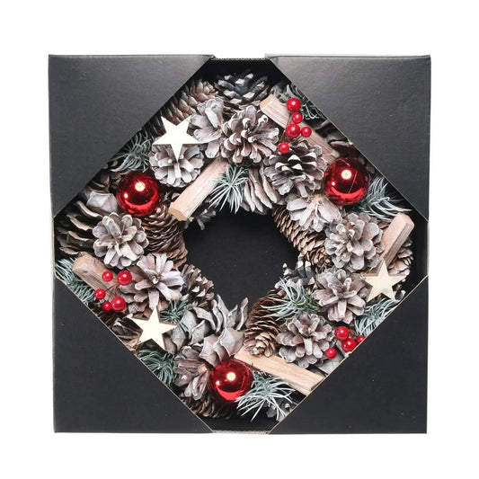 Pinecone Christmas wreath with red baubles, berries, and wooden stars in gift box