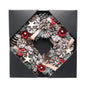 Festive pinecone wreath with red ornaments, berries, and wooden stars in gift box
