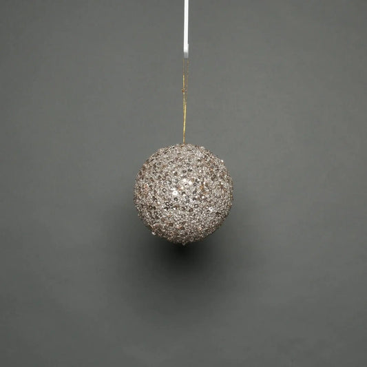 Sparkling silver sequin Christmas bauble hanging on gold string, festive holiday decoration for tree or home