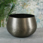 Brushed metal decorative bowl on grey surface, modern home décor accent piece