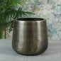 Brushed metal planter pot with modern design, home decor accessory on grey surface
