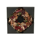 Festive pinecone wreath with red and gold accents in a black gift box, home décor