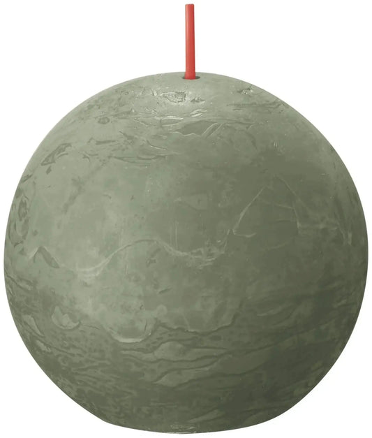 Round textured green decorative candle with red wick, home décor accent.