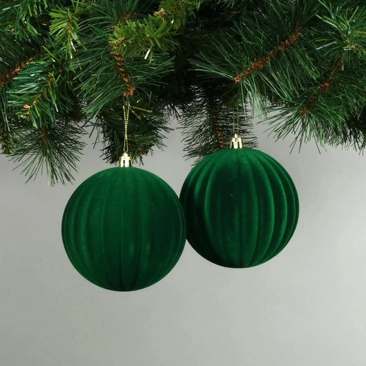 Green velvet Christmas baubles hanging on tree, festive holiday decoration