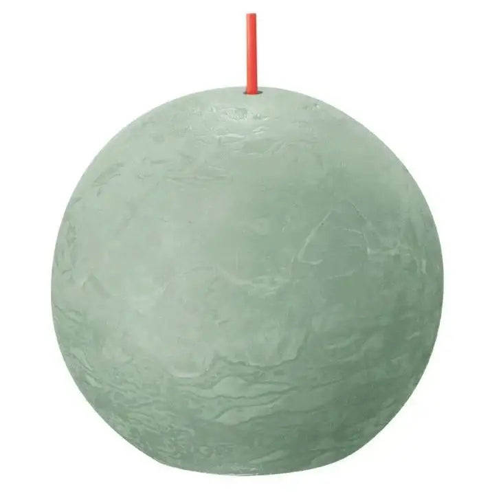 Round sage green ball candle with red wick, textured surface, home décor accent
