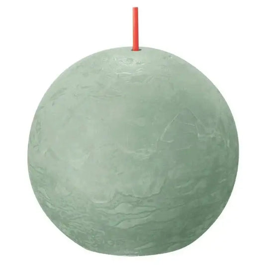 Round sage green ball candle with red wick, textured surface, home décor accent