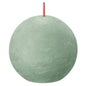 Round sage green ball candle with red wick, textured surface, home décor accent