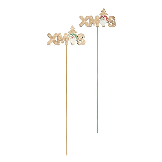 Wooden Christmas cake toppers with 'XMAS' text, Santa, and tree design on white background.