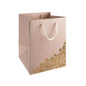 Elegant pink gift bag with gold floral design and rope handles, perfect for special occasions