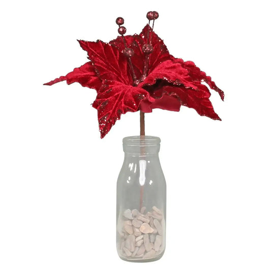 Red glitter poinsettia in glass milk bottle vase with pebbles, festive holiday décor