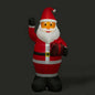 Inflatable Santa Claus holiday decoration holding a plaid gift bag on black background