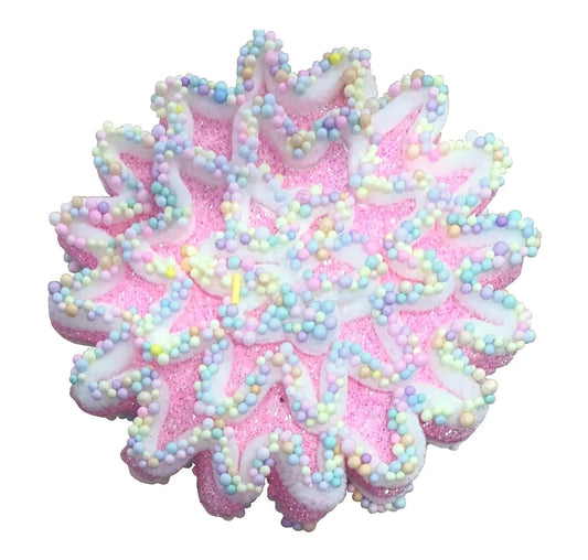 Pink snowflake-shaped bath bomb with pastel candy sprinkles, festive and gift-ready.