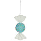 Blue candy ornament with white ends and colorful sprinkles, hanging by a silver string