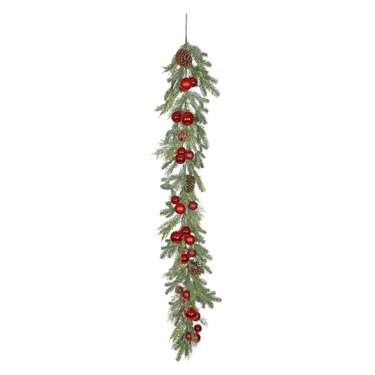 Christmas garland with pine branches, red ornaments, and pine cones for holiday decor