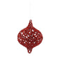 Red glittery Christmas ornament with intricate openwork design, hanging on white background