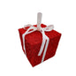 Red glitter gift box ornament with white ribbon on white background