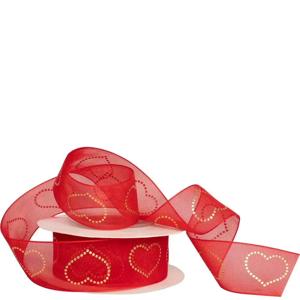 Red sheer ribbon with gold heart pattern on a spool, perfect for gift wrapping and decoration.