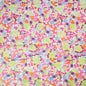 Colorful floral patterned fabric with pink, yellow, orange and purple flowers