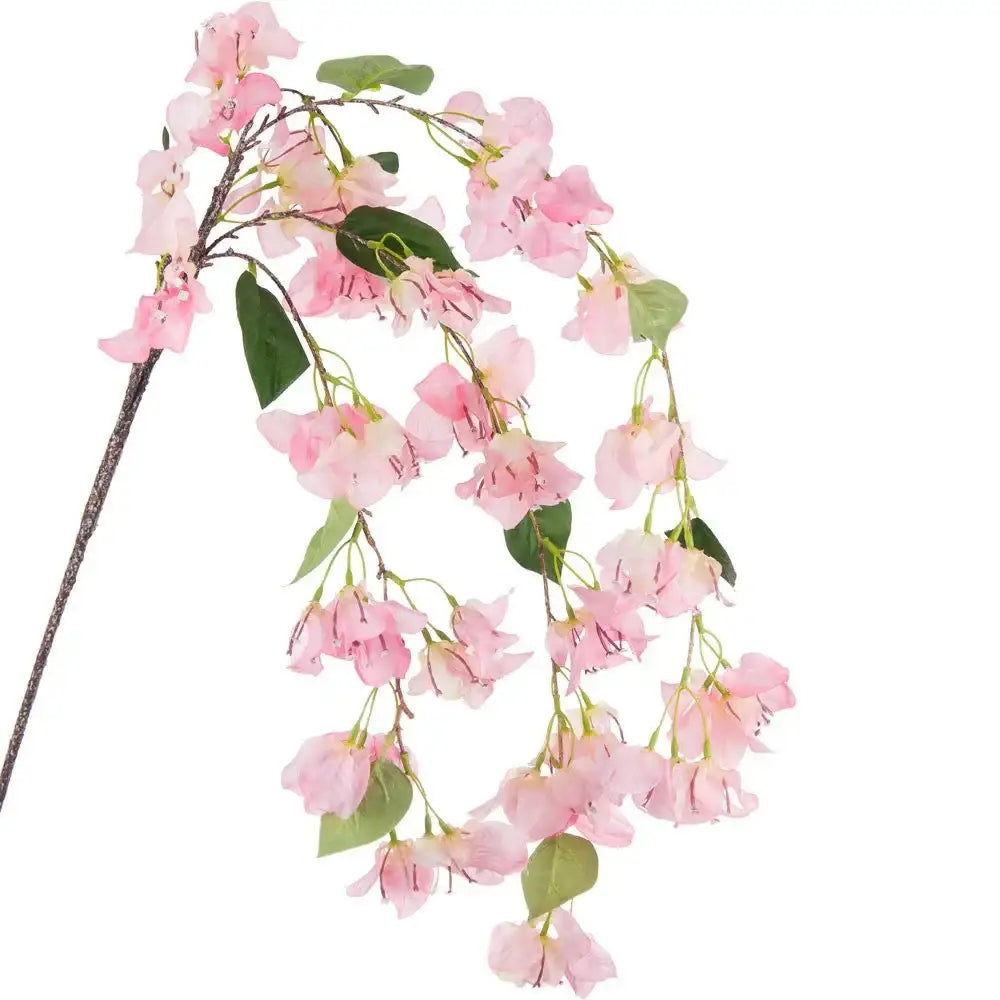 Artificial pink floral spray with delicate blossoms and green leaves on a long brown stem