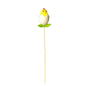 Yellow chick ornament in cracked egg with green leaves on a stick, festive home décor