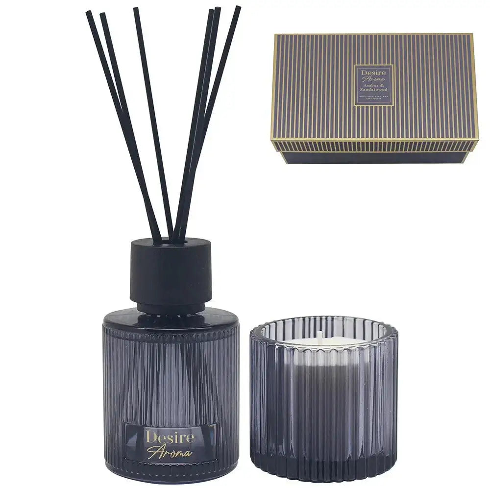 Black ribbed glass reed diffuser and candle gift set with striped box, elegant home fragrance.
