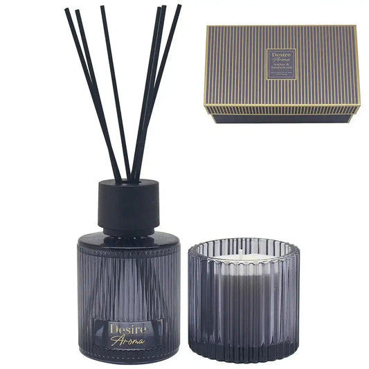 Black ribbed glass reed diffuser and candle gift set with striped box, elegant home fragrance.