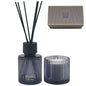 Black ribbed glass reed diffuser and candle gift set with striped box, elegant home fragrance.